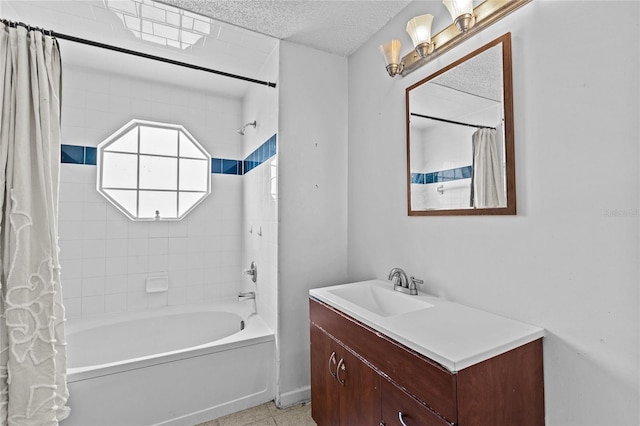 full bath featuring shower / bath combo with shower curtain, a textured ceiling, and vanity
