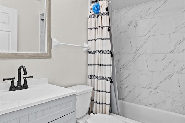 full bathroom with vanity, shower / tub combo, and toilet