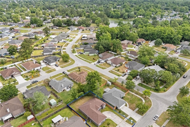 drone / aerial view with a water view and a residential view