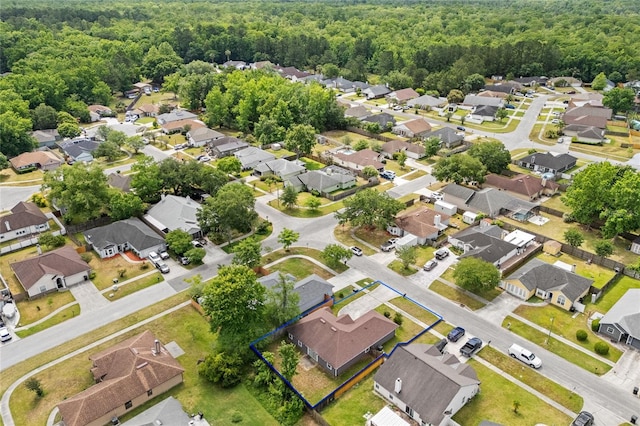 bird's eye view featuring a residential view and a forest view
