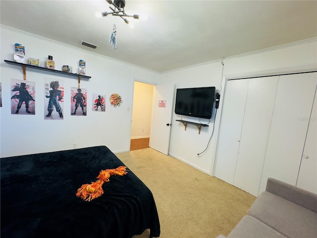 1419 Ave D NE, Winter Haven, FL 33881 - bedroom with light colored carpet, a closet, and ornamental molding