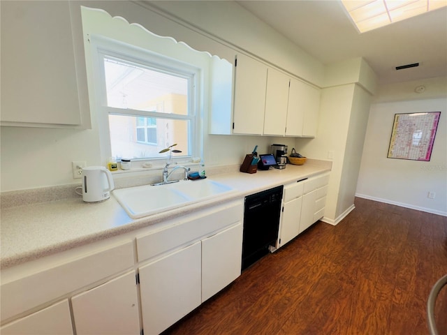 1419 Ave D NE, Winter Haven, FL 33881 - kitchen with a sink, black dishwasher, white cabinets, dark wood-style floors, and light countertops