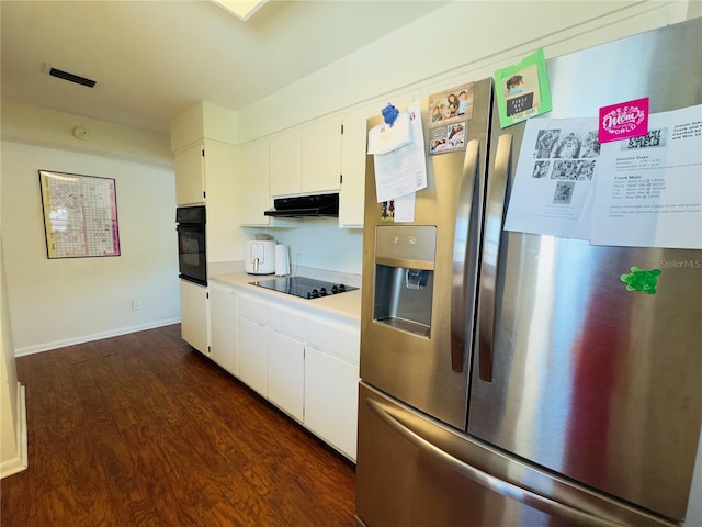 1419 Ave D NE, Winter Haven, FL 33881 - kitchen with black appliances, under cabinet range hood, dark wood-style flooring, light countertops, and white cabinets