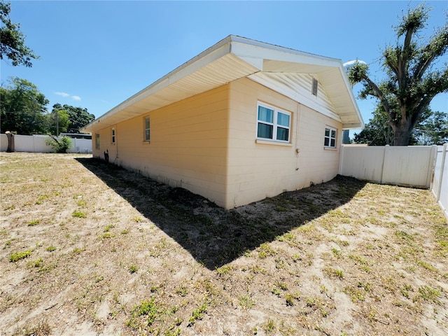 1419 Ave D NE, Winter Haven, FL 33881 - view of side of home with a fenced backyard and concrete block siding