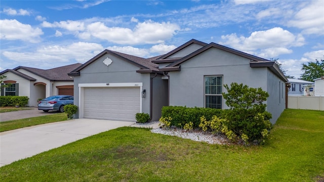 single story home with a garage, stucco siding, fence, concrete driveway, and a front yard