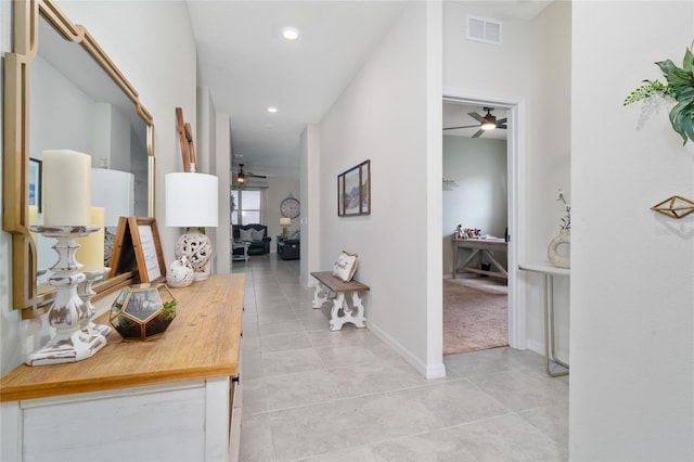 hallway featuring baseboards, recessed lighting, visible vents, and light tile patterned flooring