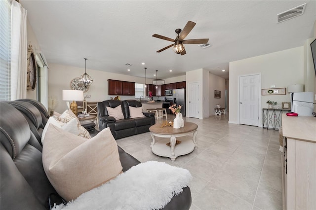 living area featuring a ceiling fan, recessed lighting, light tile patterned floors, and visible vents
