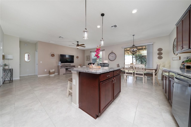 kitchen featuring stainless steel dishwasher, visible vents, ceiling fan with notable chandelier, open floor plan, and a kitchen island