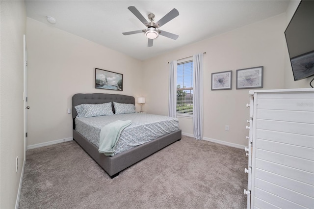 carpeted bedroom with baseboards and a ceiling fan