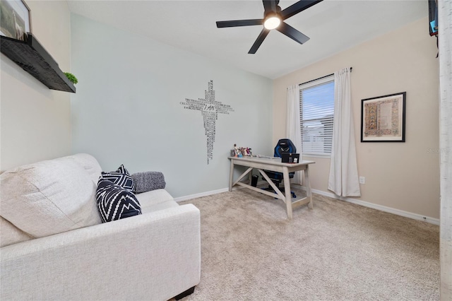 sitting room featuring a ceiling fan, baseboards, and carpet floors