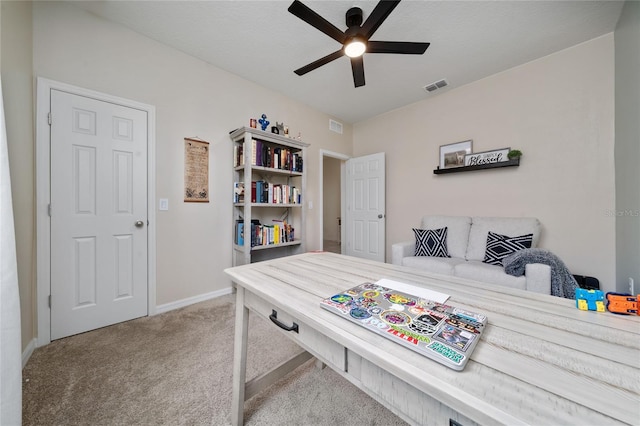 home office with visible vents, baseboards, ceiling fan, and carpet floors