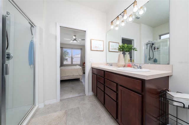 ensuite bathroom with double vanity, visible vents, a shower stall, and a sink