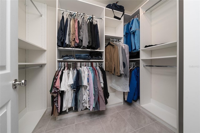 walk in closet with tile patterned flooring