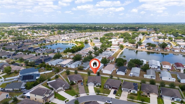 drone / aerial view featuring a water view and a residential view