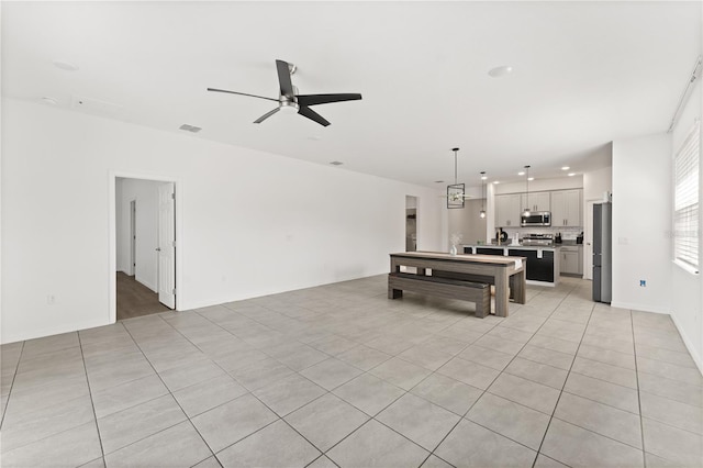 game room with a ceiling fan, light tile patterned floors, and visible vents