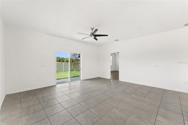 tiled spare room with visible vents and ceiling fan