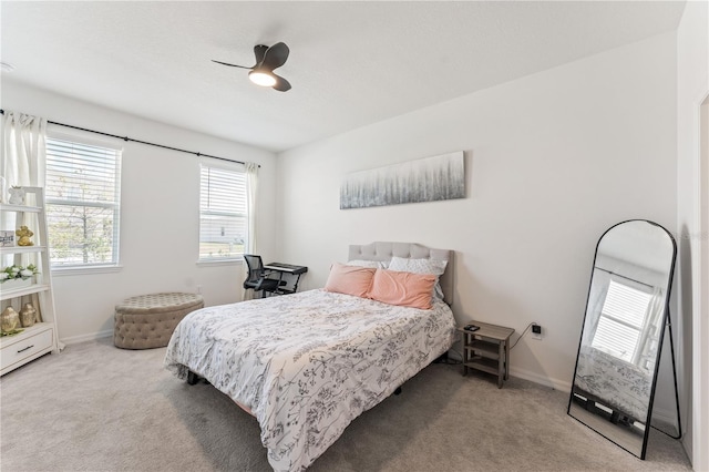 carpeted bedroom with baseboards and ceiling fan