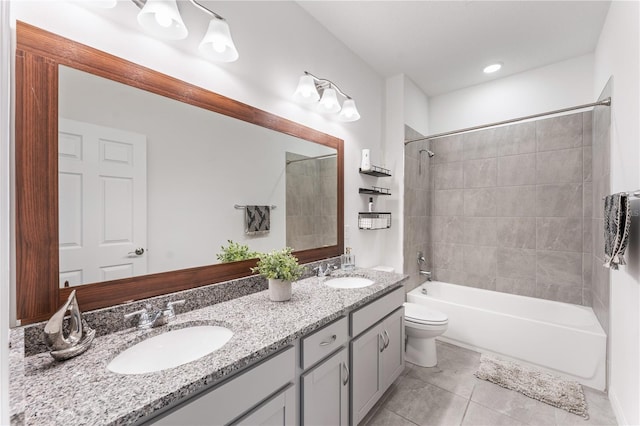 full bathroom featuring a sink, tub / shower combination, toilet, and tile patterned floors