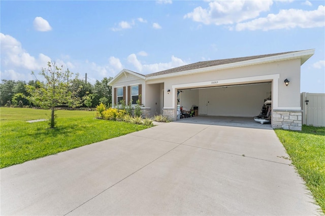 ranch-style home with stone siding, an attached garage, stucco siding, concrete driveway, and a front yard