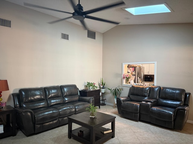 living area featuring light tile patterned floors, visible vents, and high vaulted ceiling