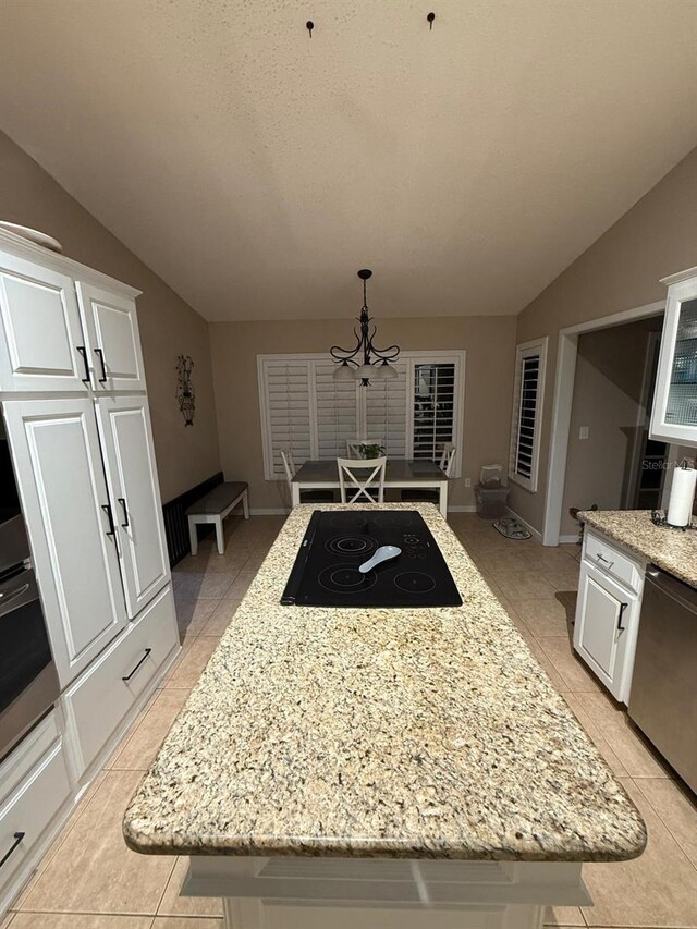 interior space with vaulted ceiling, a chandelier, baseboards, and light tile patterned floors