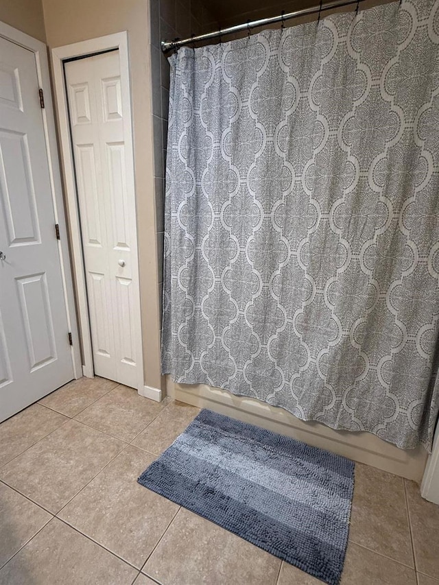 bathroom with tile patterned floors and shower / bath combination with curtain