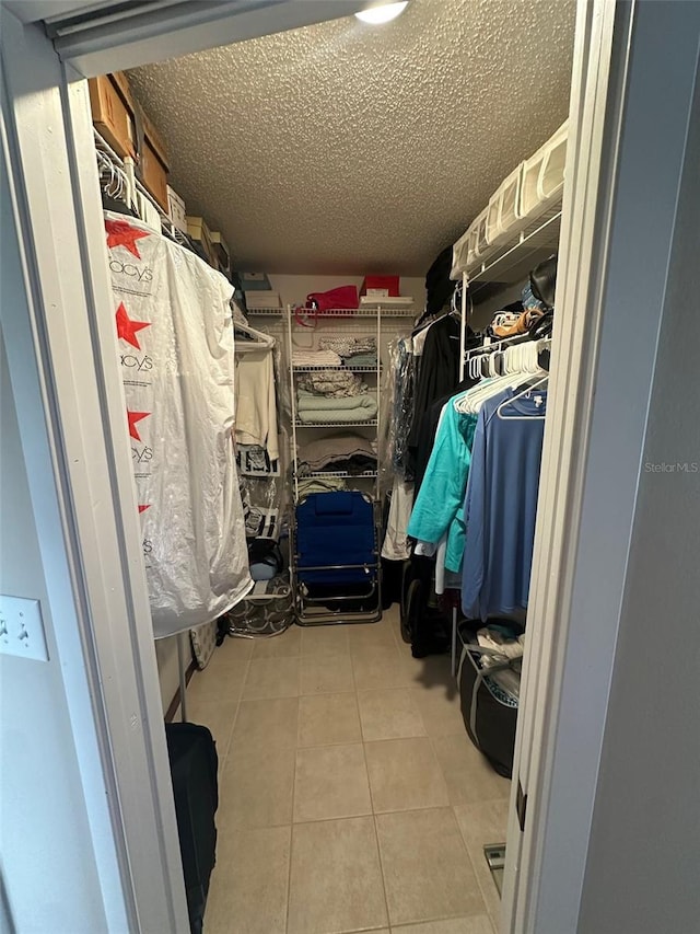 spacious closet featuring tile patterned flooring