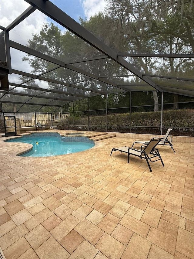 pool with a fenced backyard, a lanai, and a patio