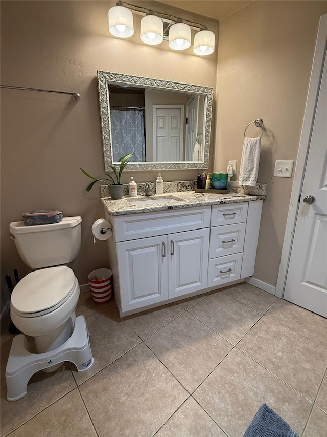 full bathroom featuring toilet, tile patterned floors, and vanity