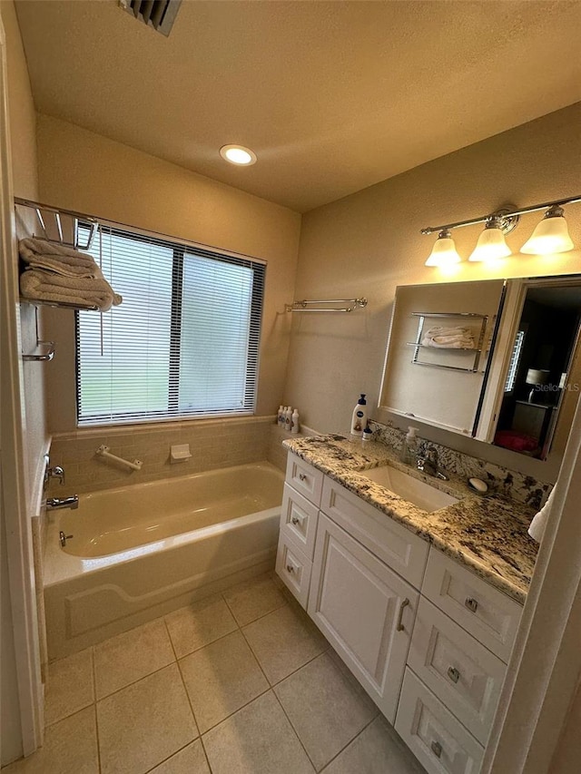 full bath with a bath, a textured ceiling, visible vents, tile patterned flooring, and vanity