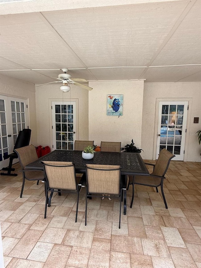 interior space with french doors and ceiling fan