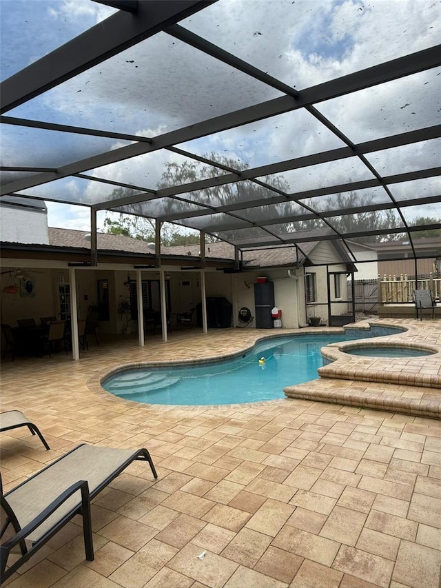 view of pool featuring a patio area, fence, and a lanai