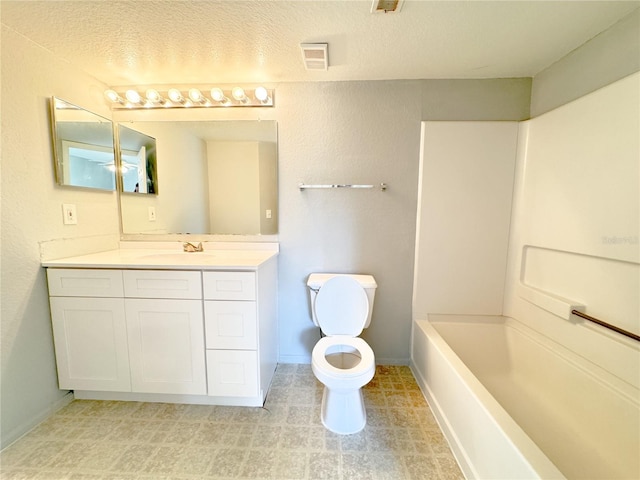 bathroom featuring vanity, toilet, a textured ceiling, and visible vents
