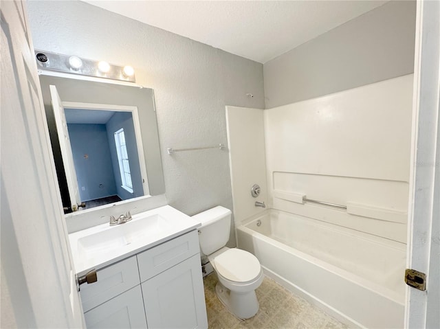 bathroom featuring a textured wall, toilet, vanity, and washtub / shower combination