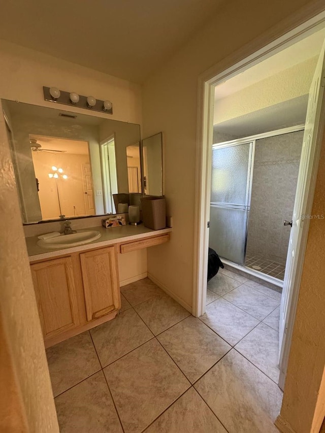 bathroom featuring vanity, tile patterned flooring, and a stall shower