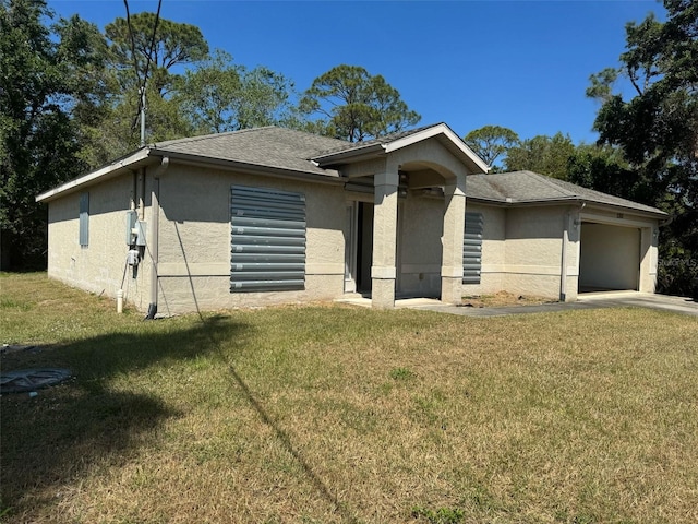ranch-style house with a front yard, stucco siding, and a garage