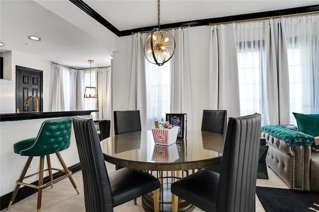 dining room with recessed lighting, an inviting chandelier, and crown molding