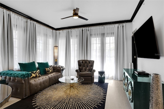 living area with a ceiling fan and wood finished floors