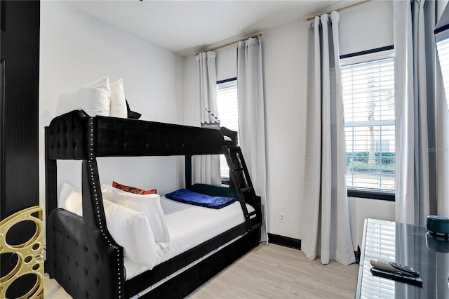 bedroom featuring baseboards and wood finished floors