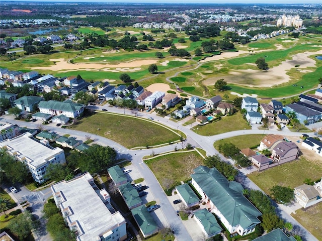 birds eye view of property with golf course view and a residential view