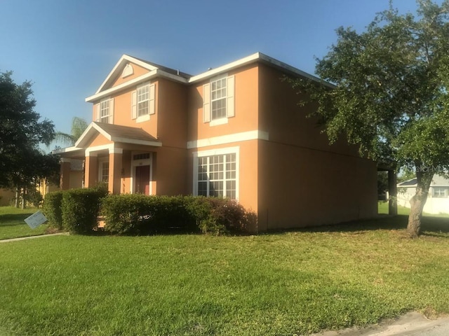 3102 Westbrook Rd, Kissimmee, FL 34746 - view of side of home featuring a yard and stucco siding