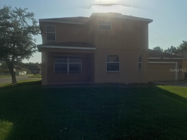 3102 Westbrook Rd, Kissimmee, FL 34746 - rear view of house with a yard and a garage