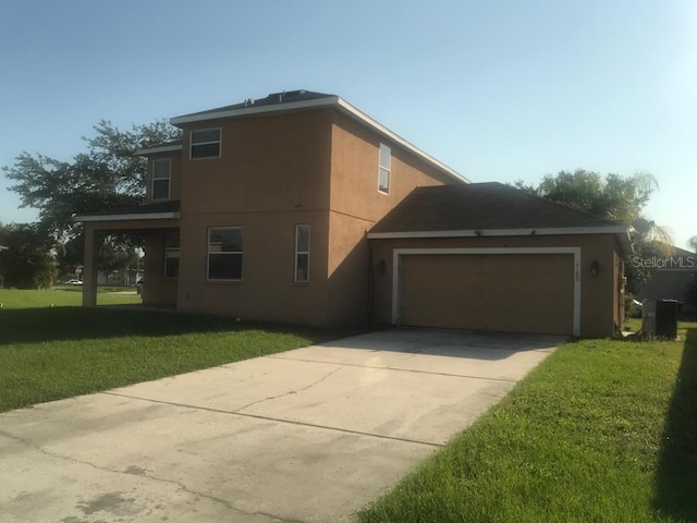 3102 Westbrook Rd, Kissimmee, FL 34746 - view of side of home featuring driveway, an attached garage, stucco siding, and a lawn