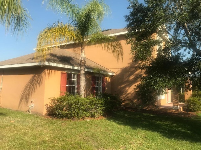 3102 Westbrook Rd, Kissimmee, FL 34746 - exterior space with a yard and stucco siding
