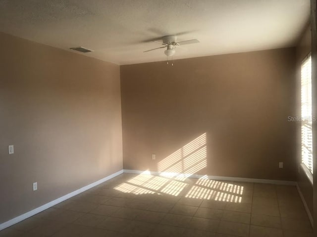 3102 Westbrook Rd, Kissimmee, FL 34746 - tiled empty room with baseboards, a ceiling fan, plenty of natural light, and visible vents