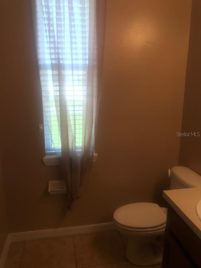 3102 Westbrook Rd, Kissimmee, FL 34746 - bathroom with vanity, toilet, baseboards, and tile patterned floors