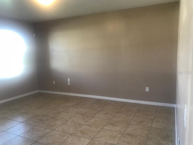 3102 Westbrook Rd, Kissimmee, FL 34746 - unfurnished room featuring light tile patterned floors and baseboards