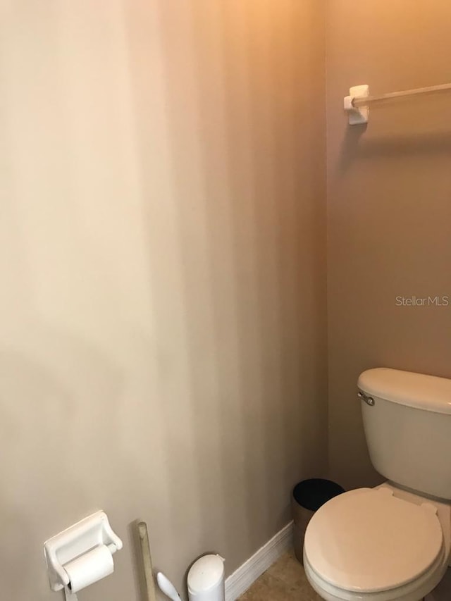 3102 Westbrook Rd, Kissimmee, FL 34746 - bathroom featuring toilet, tile patterned flooring, and baseboards