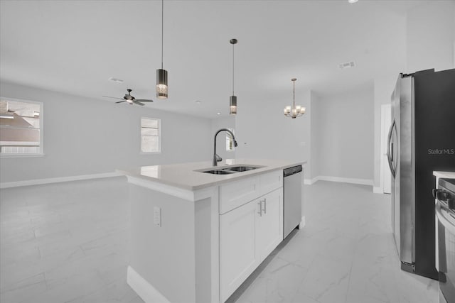 kitchen featuring a sink, stainless steel appliances, light countertops, and marble finish floor