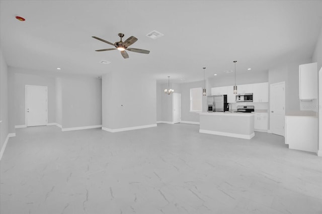 unfurnished living room with recessed lighting, baseboards, visible vents, a sink, and ceiling fan with notable chandelier